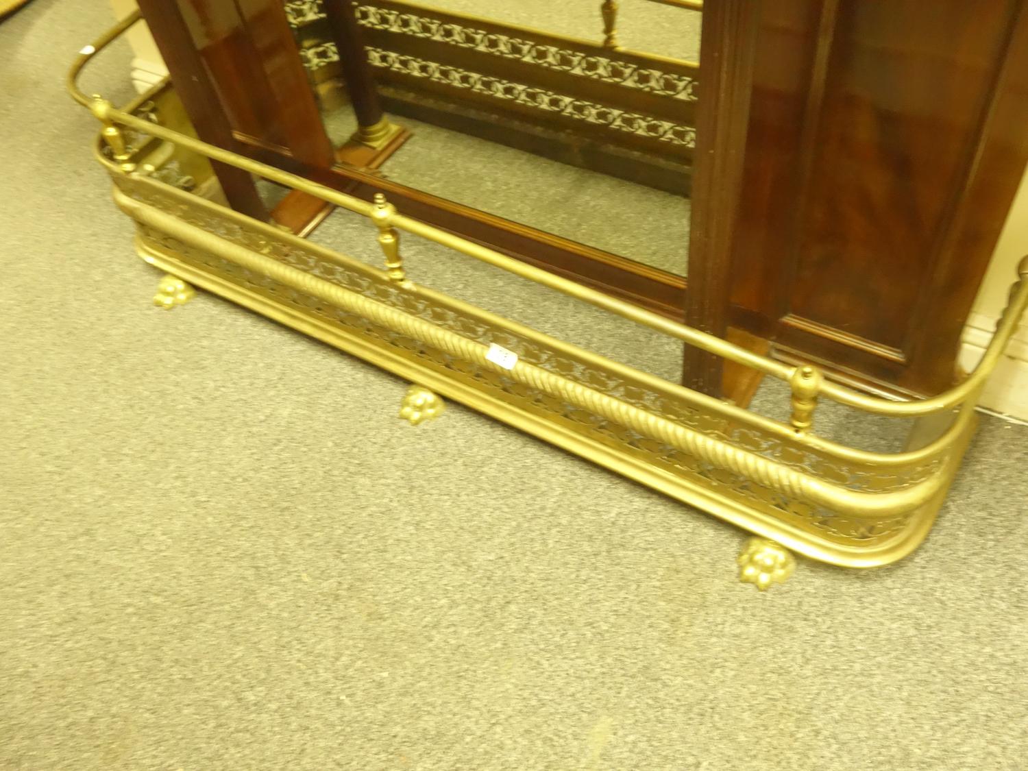 Decorative pierced brass fire front, with lion paw supports, 5' long with a galleried top
