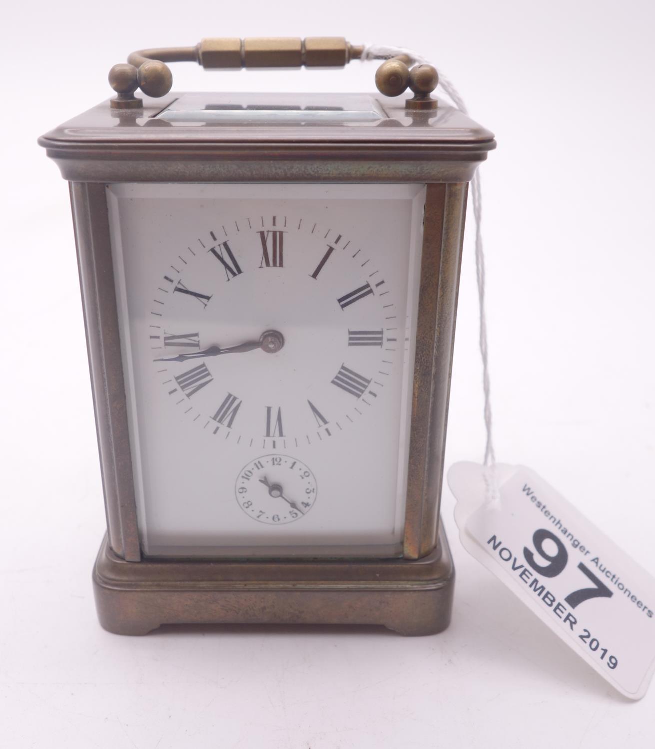 French early 20th century small travelling alarm clock with 4 glass sides, visible escapement to the
