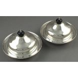 A pair of silver muffins dish, Edward Viner, Sheffield 1932, the domed covers with ebonised handles,