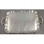 A silver oblong tray, Sheffield 1931, Edward Viner, of ogee shaped rectangular form with twin