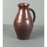 St Ives Pottery jug, dark red glaze decorated with a chevron pattern, seal mark below the handle,