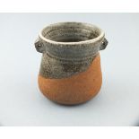 Janet LEACH (American 1918-1997) a waisted stoneware pot, with pierced lugs to neck and speckled