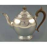 A silver teapot, London 1929, Edward Barnard, of globular form raised on a pedestal base with bobbin