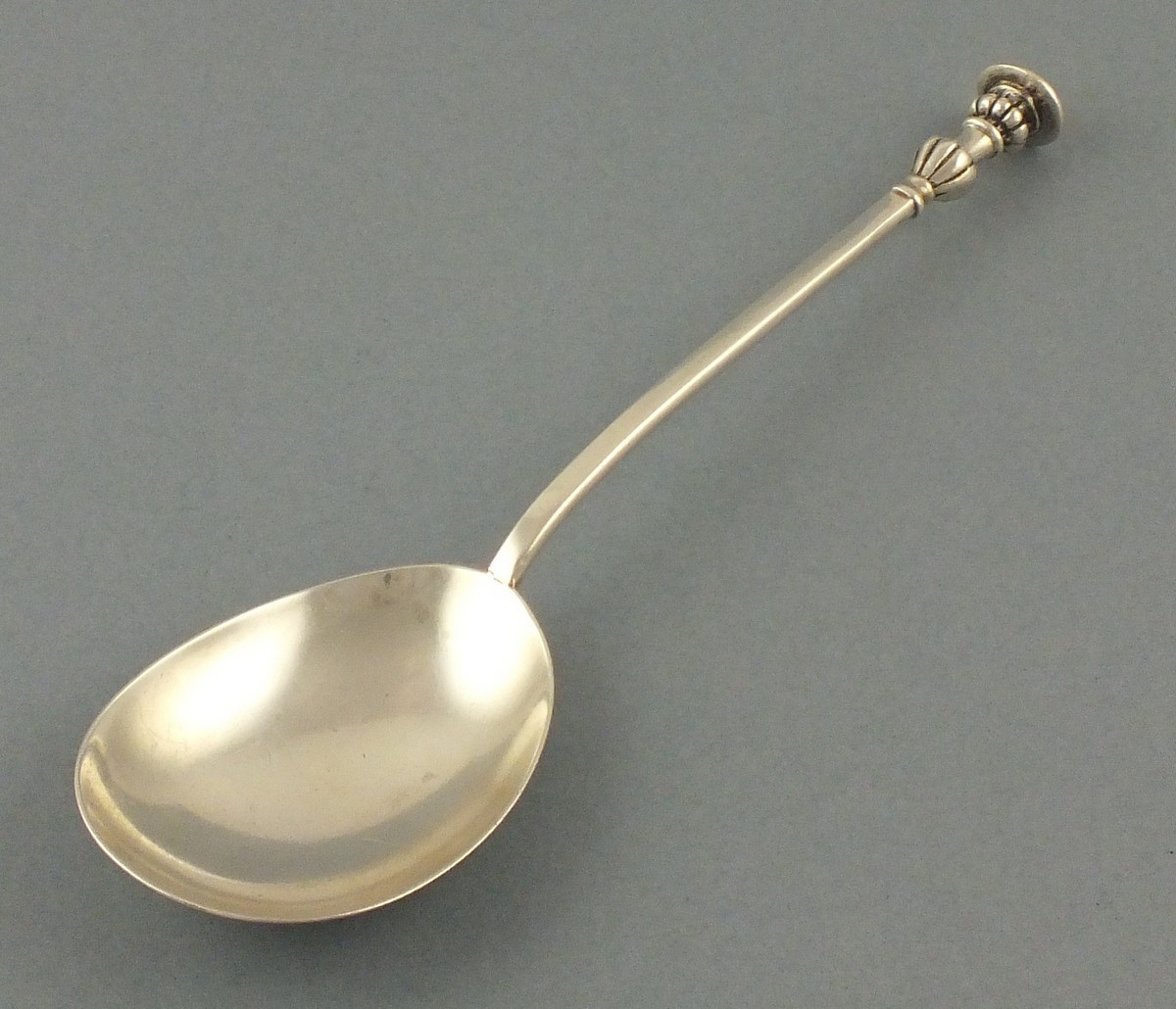 A silver 'seal-top' spoon, London 1909, William Hutton & Sons, with a fluted baluster shaped top,