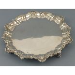 A circular silver salver, London 1928, Robert Pringle, the pie-crust edge with scallops, and