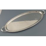 A silver twin handled tray, Sheffield 1918, Atkin Bros, of elongated oval form, the centre