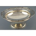 A circular silver fruit bowl, Sheffield 1928, Mappin & Webb, with a pierced rim of foliate swags,