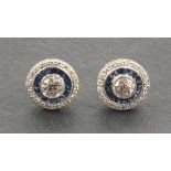 A pair of 18ct white gold old cut diamond and sapphire target style stud earrings, total diamond