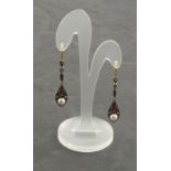 A pair of drop earrings set with rubies, diamonds and pearls