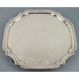 A square silver salver, Sheffield 1929, Eric Viner, with moulded lip and cusped corners, raised on