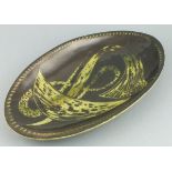 Graham FLIGHT (British 20th Century) brown and green glazed pottery dish, of oval form incised