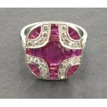 A platinum art deco style ruby and diamond panel ring set with a central oval shaped ruby.