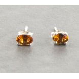 A pair of orange tourmaline ear studs