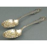 A pair of silver berry spoons, Sheffiled 1894, Henry Wigfull, with gilt repousse bowls decorated