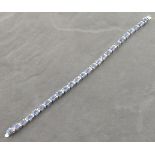 An 18ct white gold sapphire and diamond line bracelet, 18cm long, 14.5g. Illustrated