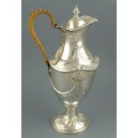 A silver wine ewer, London, 1897, Henry Stratford, repousse decorated with bow-tied swags and raised