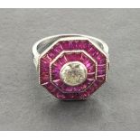 An octagonal shaped platinum ruby and diamond dress ring set with a central old cut diamond, a