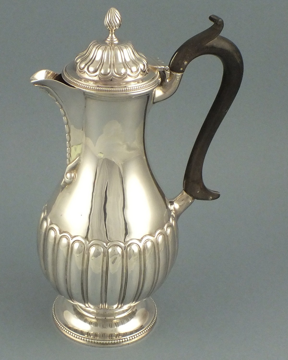 A sliver hot water jug, London 1899, Charles Stuart Harris, of baluster form and part fluted body,