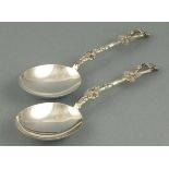 A pair of silver fruit servers, Sheffield 1908, Harrison Bros., the handles cast with vine leaves,