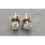 A pair of 14ct white gold treated diamond ear studs, approximately 1.05ct. Illustrated
