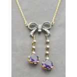 A gold and silver bow style necklace set with amethysts and seed pearls. Illustrated