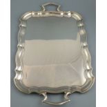 An impressive silver tray Sheffield 1931, of rectangular form with an ogee shaped border and twin