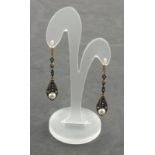 A pair of drop earrings set with sapphires, diamonds and pearls