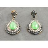A pair of drop earrings set with a pear drop cabochon jade gemstone surrounded by diamonds and onyx