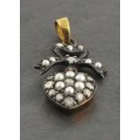 Heart shaped bow top pendant set with diamonds and seed pearls