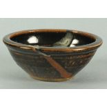 Sylvia HARDAKER (British 20th Century) Tenmoku glazed bowl with a white run, impressed marks, 6.