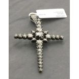 A diamond set pendent in the form of a cross, 4.5gms
