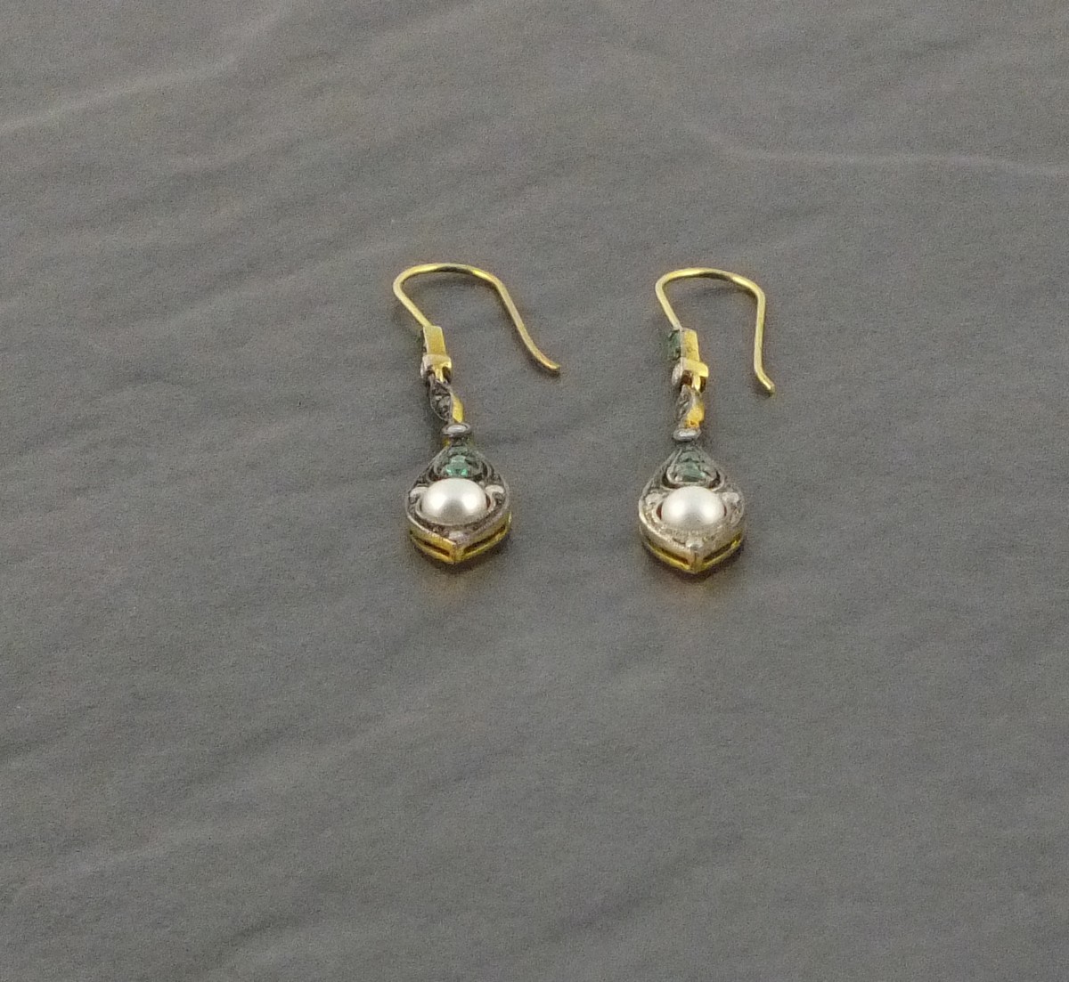 A pair of drop earrings  set with emeralds and pearls