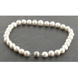 A string of cultured pearls with a 9ct white gold satin effect ball clasp