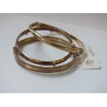 Three rolled gold hinged bangles
