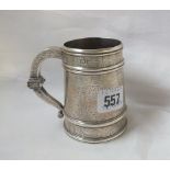 Good half pint mug, churn shaped body engraved with masks and geometric panels, having heavy knopped