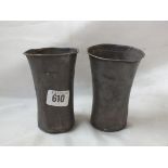 A pair of eastern European trumpet shaped white metal beakers, each engraved with an inverted