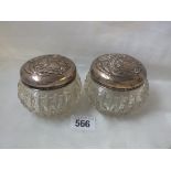 A pair of Art Nouveau cut glass dressing table jars with floral embossed covers 3.5" dia. B'ham 1904