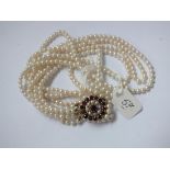 Four strand pearl necklace with 9ct garnet and pearl clasp