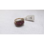 A red stone & diamond bordered ring set in 9ct