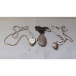 Three silver lockets on chains