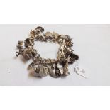 A heavy silver charm bracelet – 121g