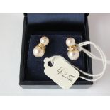 Pair of diamond and pearl ear studs set in gold