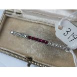 White gold mounted ruby & diamond bar brooch in fitted case 6g inc