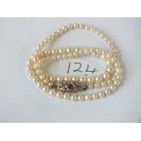 SINGLE ROW OF NATURAL PEARLS 17" long set with 9ct ruby & diamond clasp 15g inc