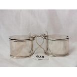 Pair of oval mustard pots with shell thumb pieces, 3.5” over handle B’ham 1919 by D & F 100g.