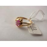 An oval pink stone ring, set in 18ct gold, cross over shank size N