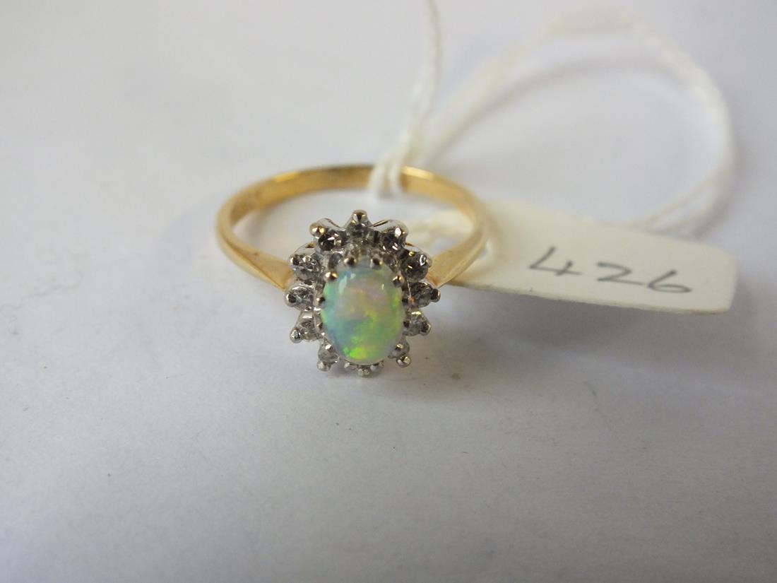 Oval opal and diamond cluster ring set in gold, size M