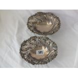Pair of Victorian bonbon dishes with floral rims and pierced swirl reeded sides on cast supports, 6”
