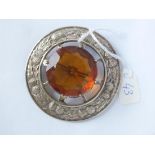 Large circular 7cm silver kilt brooch set with central orange stone
