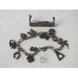 Silver and marcasite brooch, and similar bracelet with charms